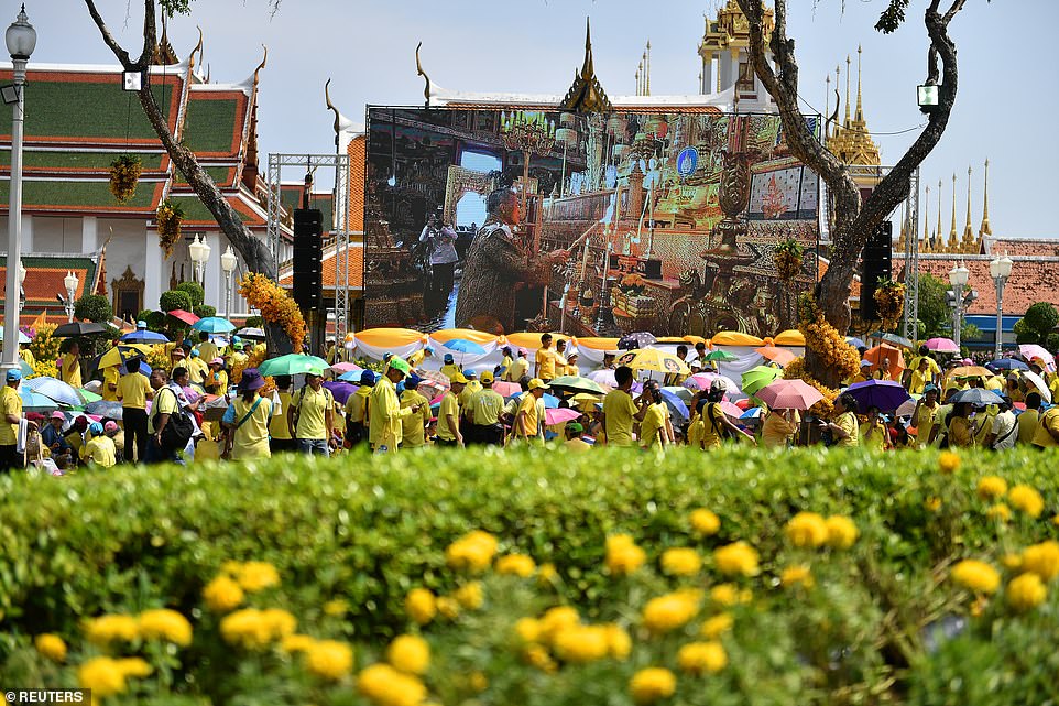 1406-6996795-People_watch_the_coronation_procession_for_Thailand_s_newly_crow-a-83_1557141418496.jpg